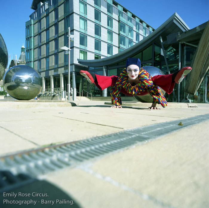 Emily Rose as Harlequin outisde the Winter Gardens in Sheffield as part of Circus Future's - Barry Pailing & Greentop Circus